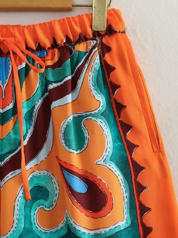 Orange satin pants with colorful patterns