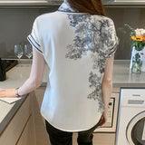 chemisier satin noué floral noir et blanc