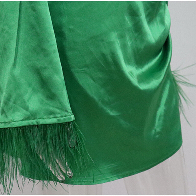 Green satin dress with feathers